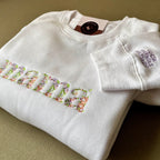 Buzo bordado floral "MAMÁ" personalizado