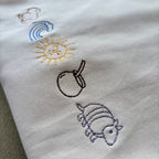 Remera bordada con símbolos uruguayos