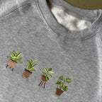 Buzo con plantas bordadas