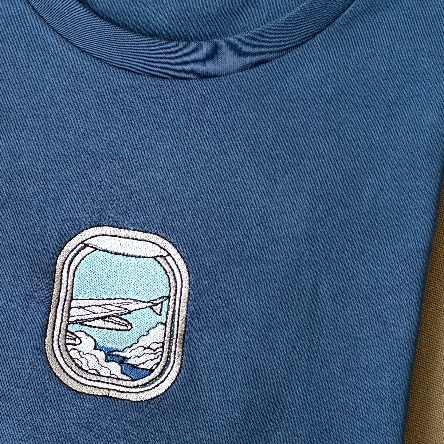 Remera con ventana de avión bordada