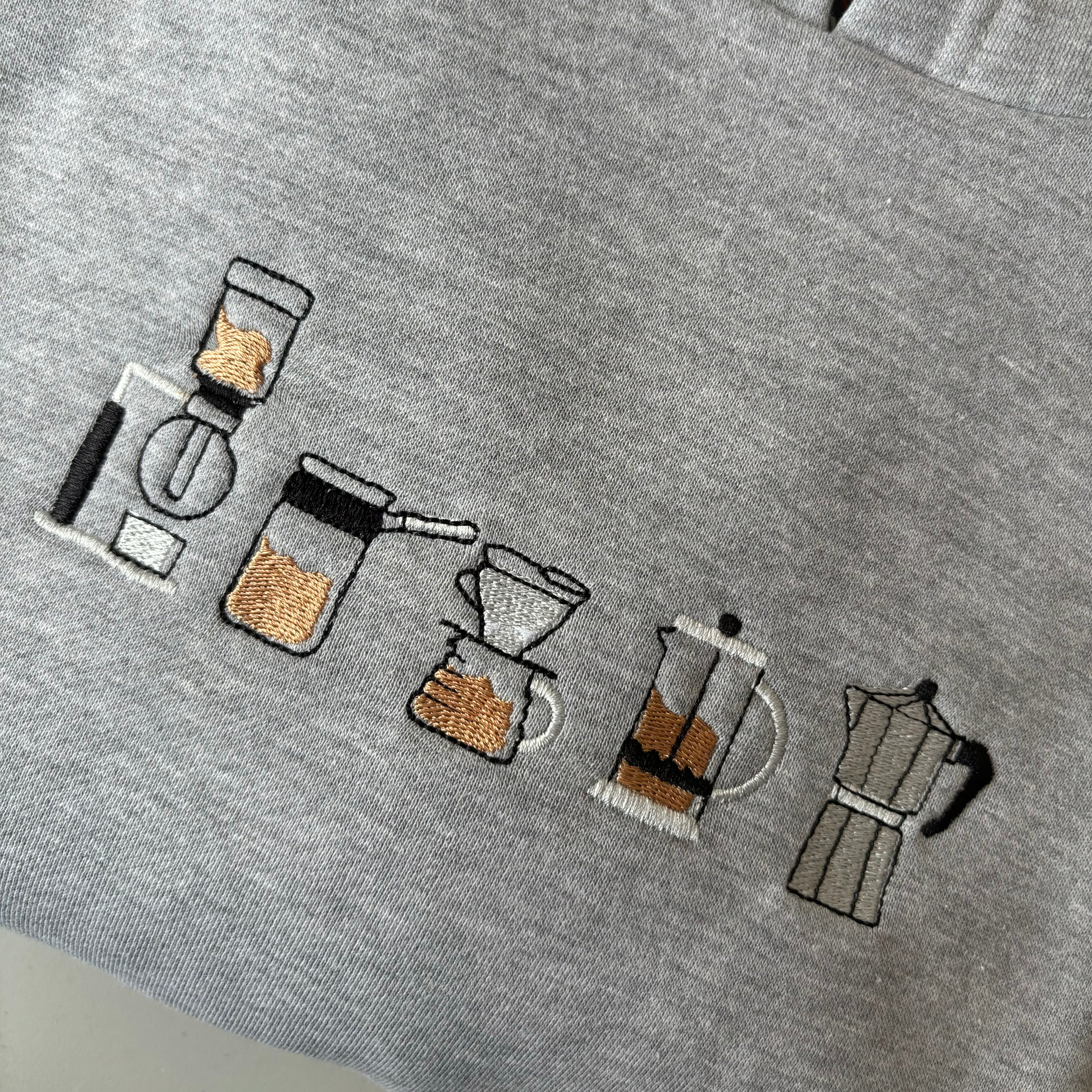 Canguro con cafeteras bordadas