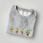 Buzo con plantas bordadas