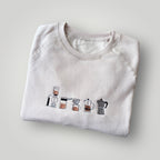 Buzo con cafeteras bordadas